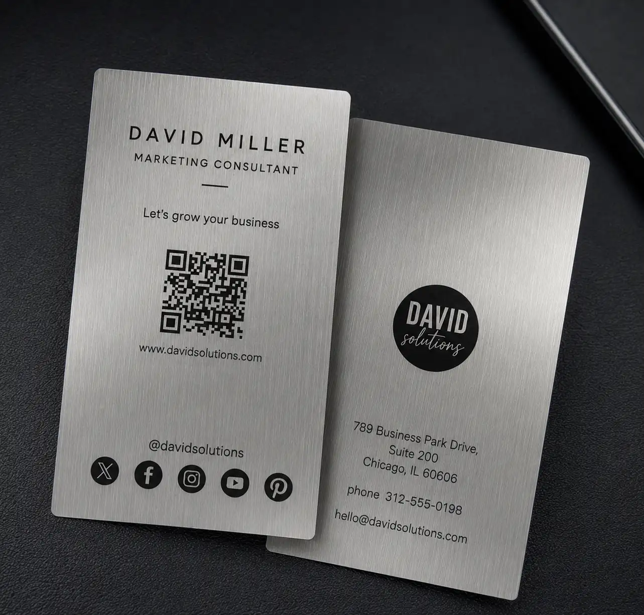 Brushed silver metallic paper business card with black printing