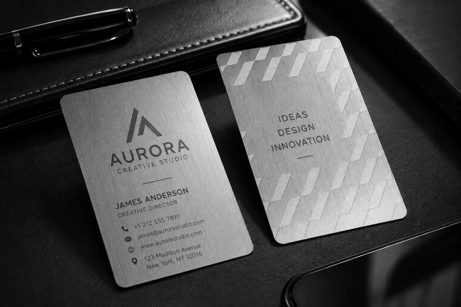 Light platinum metallic paper business card with deboss detail and grey printing