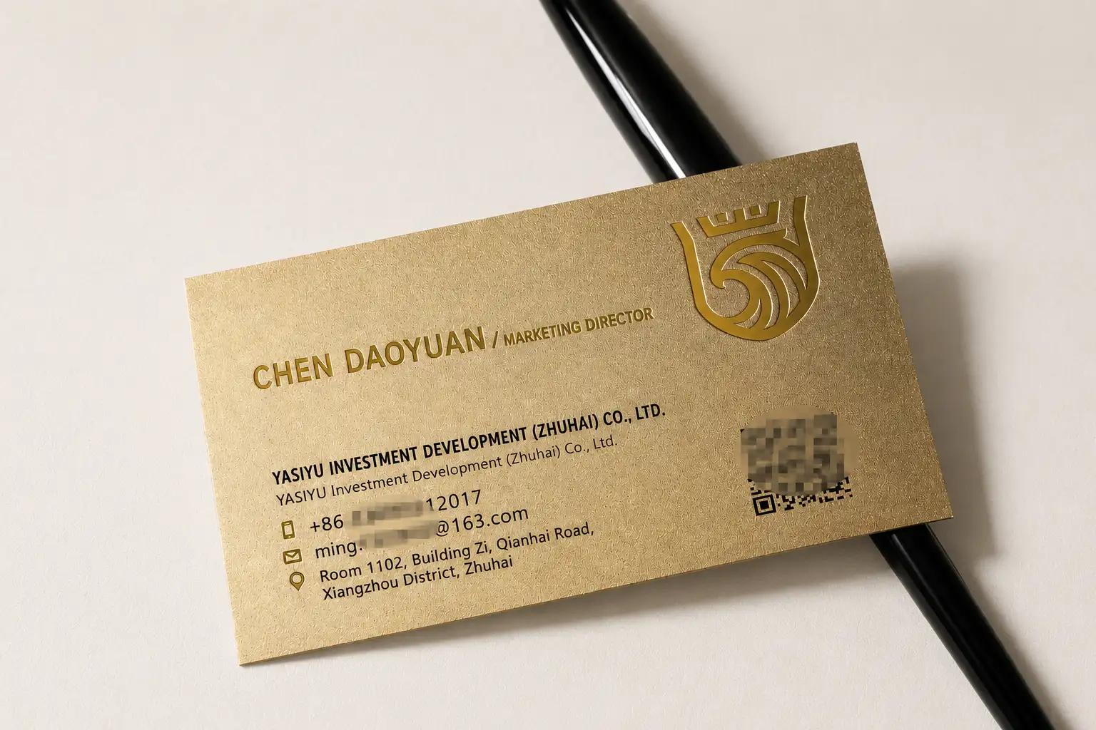 Bright sand gold metallic paper business card with black printing and debossing