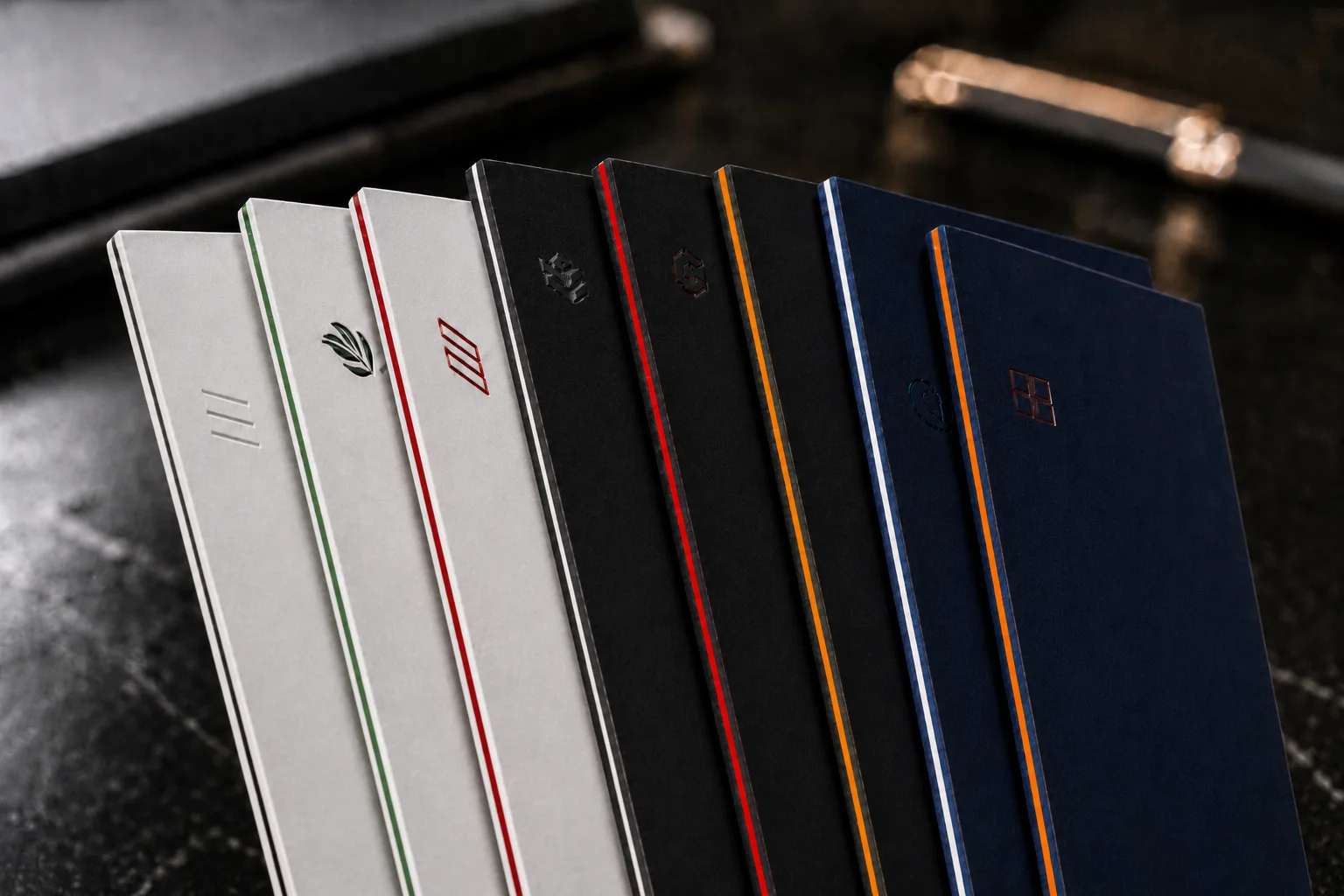 Eight 48pt Color Core business cards fanned out, showing white, black and navy faces with colored layered edges
