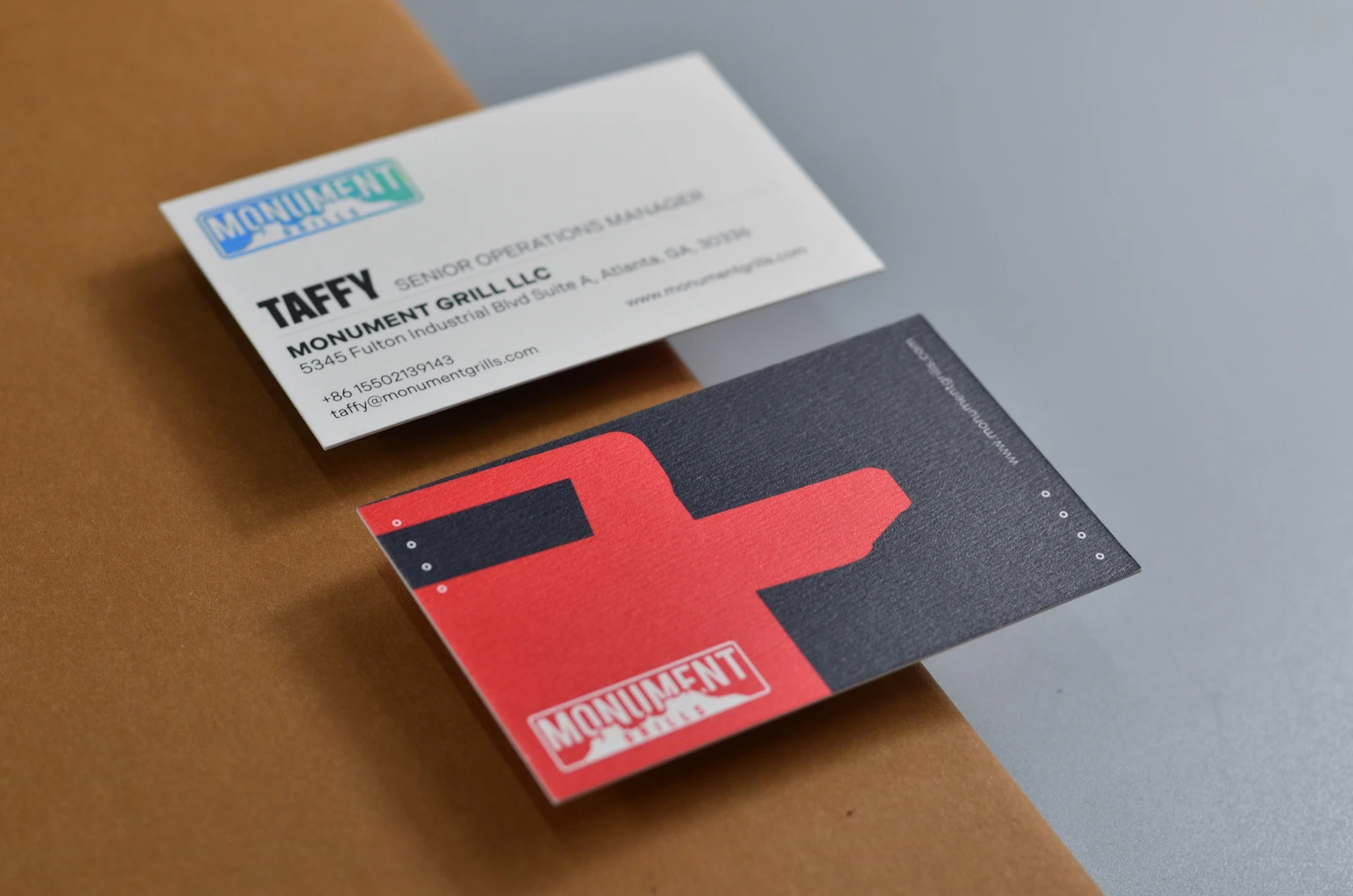 600gsm elegant white textured paper business card with red and blue full coverage printed areas and visible uncoated surface texture