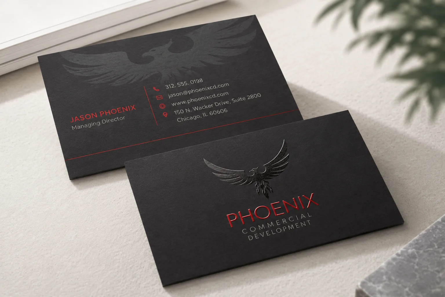 Black matte business card with red printed details and clear spot UV gloss pattern