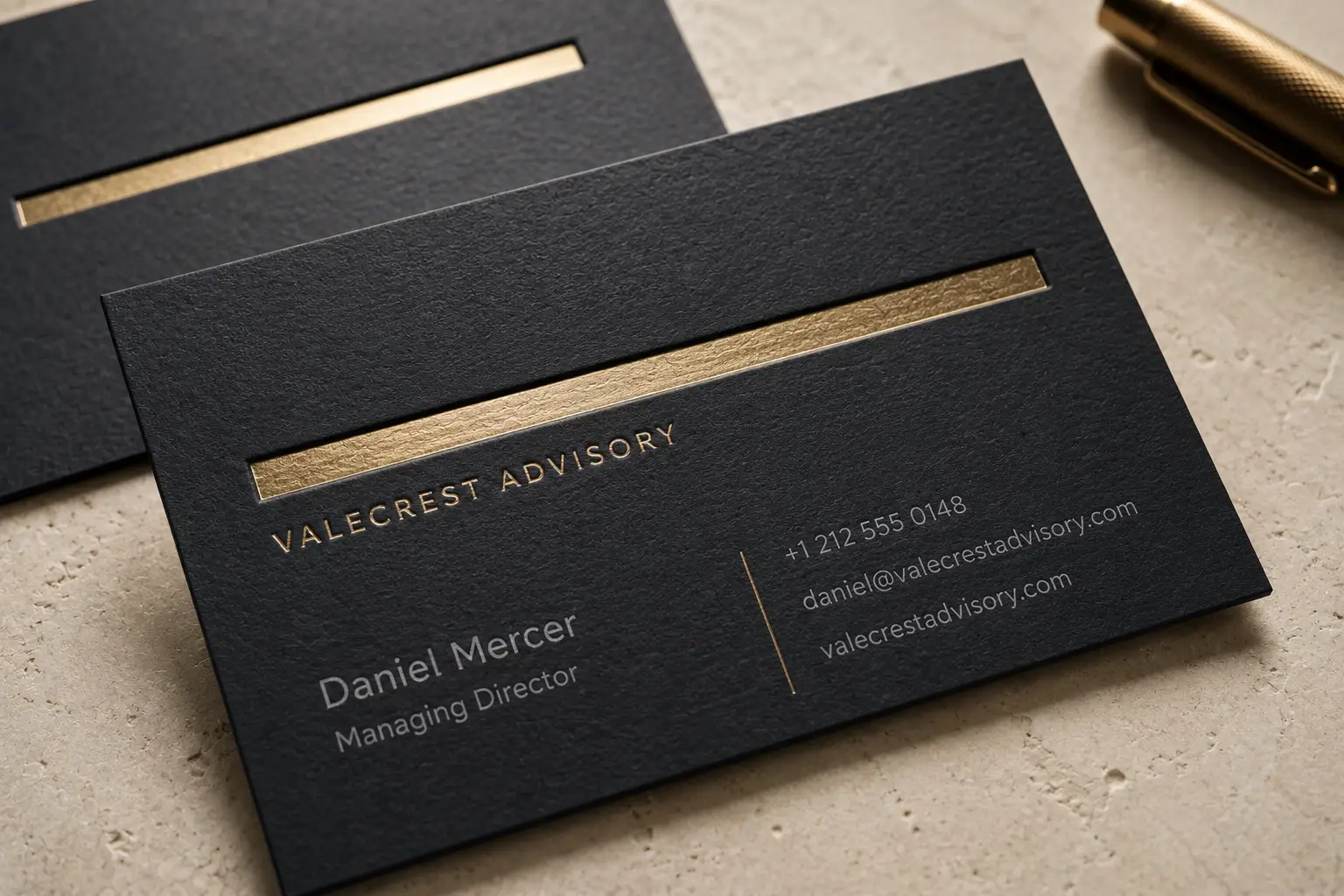 Black matte business card with subtle debossed details and a restrained gold foil line for a premium advisory brand.