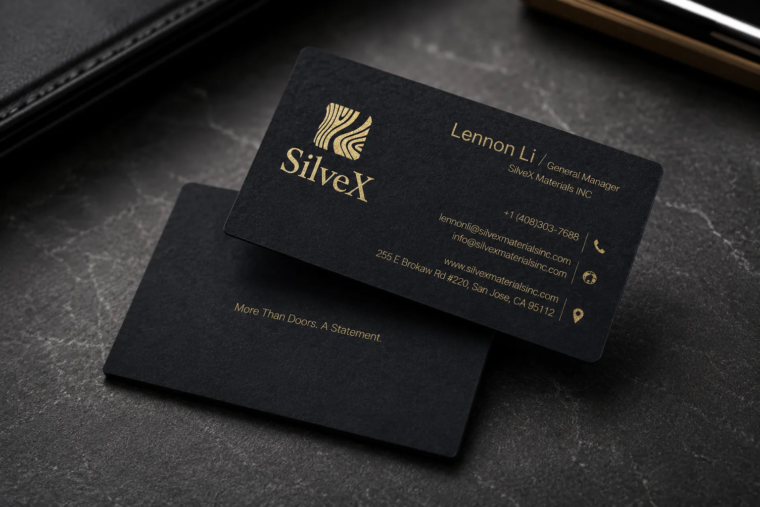 Black matte business card with gold foil logo and restaurant or lounge style contact details.