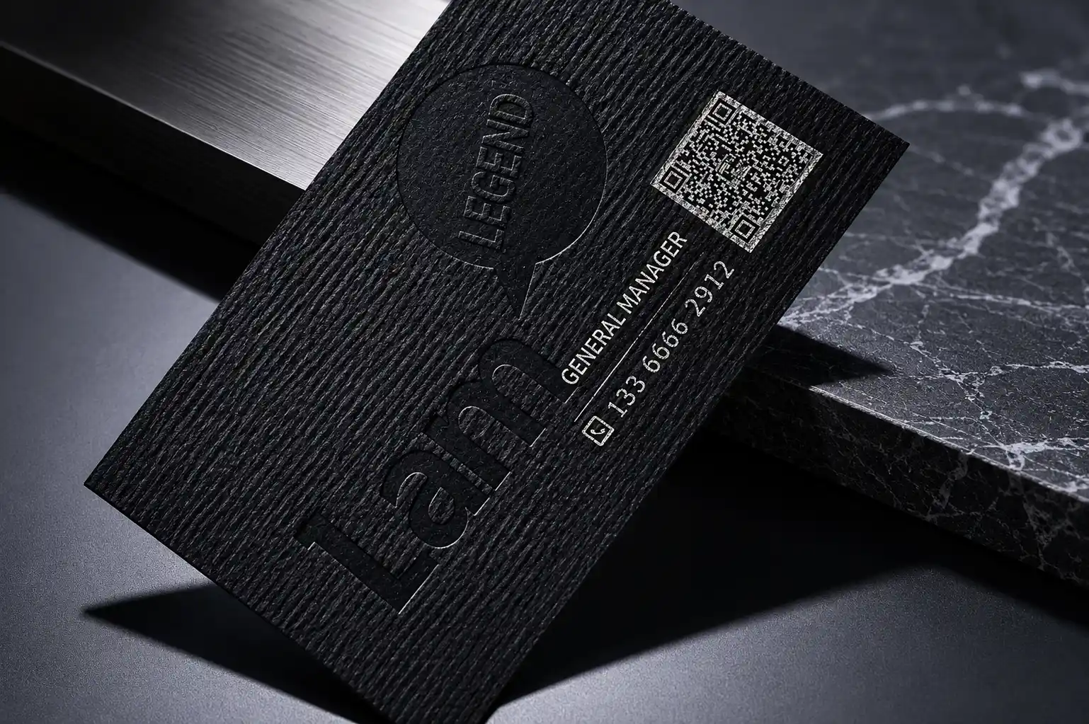 Black fine horizontal ribbed textured paper business card with subtle gloss detail and QR code