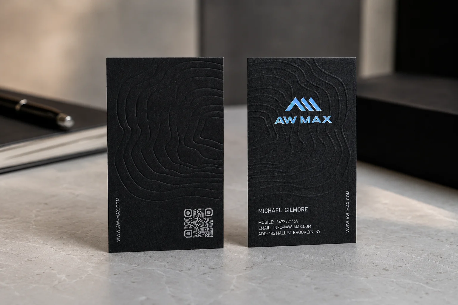 Black business card set with QR code detail, dark matte paper and modern technology brand typography.