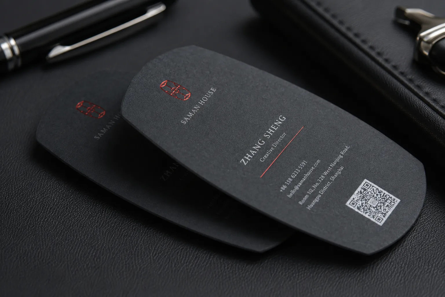 Black tag shape business card with custom die cut outline and printed contact layout