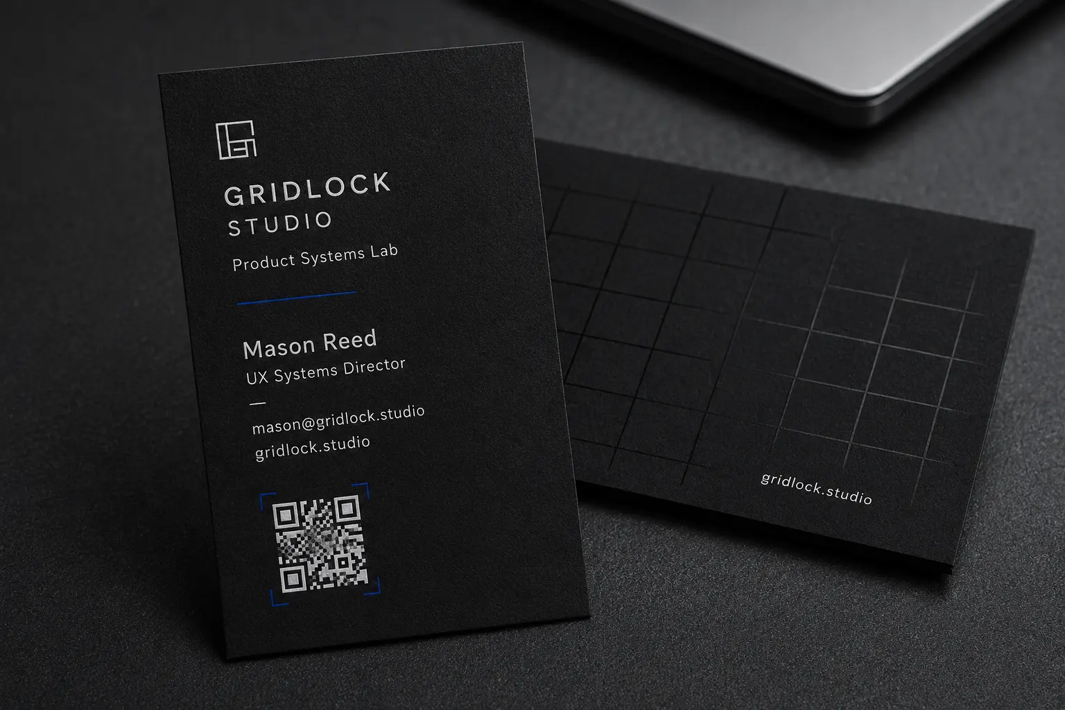Modern black business cards with white ink contact details, a clean QR code layout and subtle black-on-black grid texture.