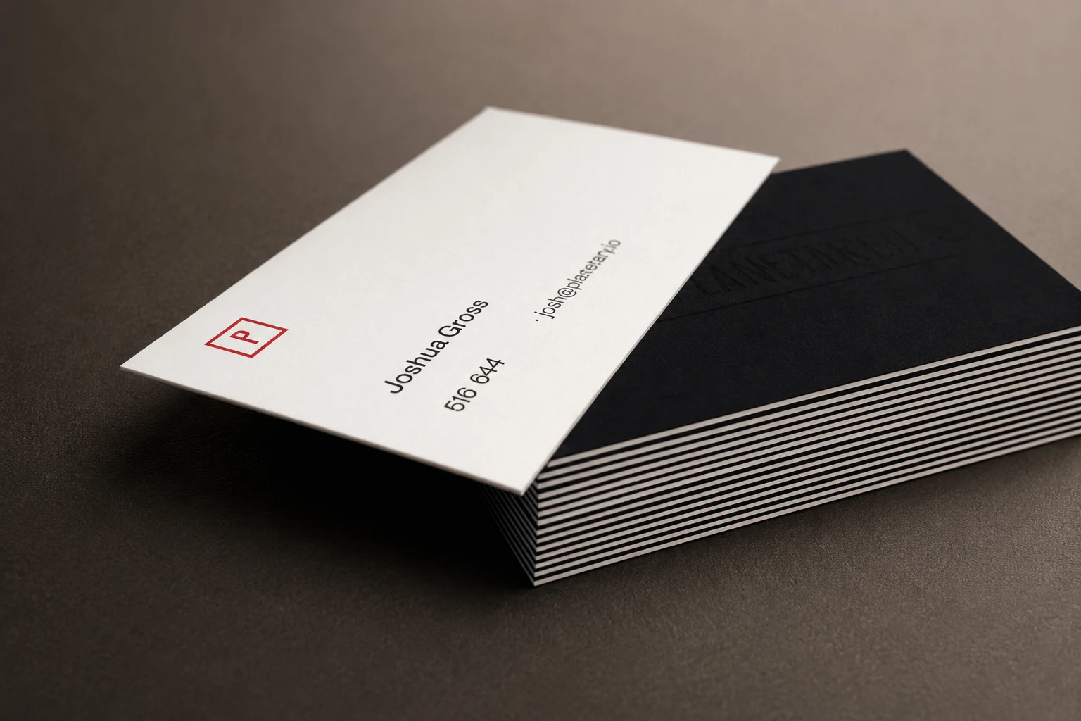 Side view of thick duplex business cards showing black and white paper sheets bonded together