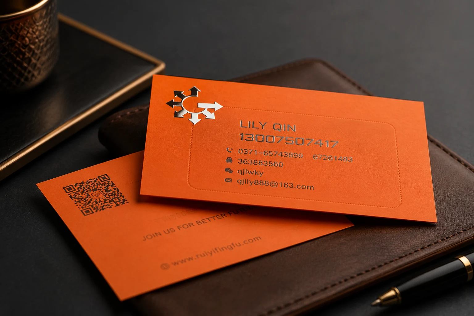 Orange brand color soft touch business cards with matte surface and clean contact information layout.