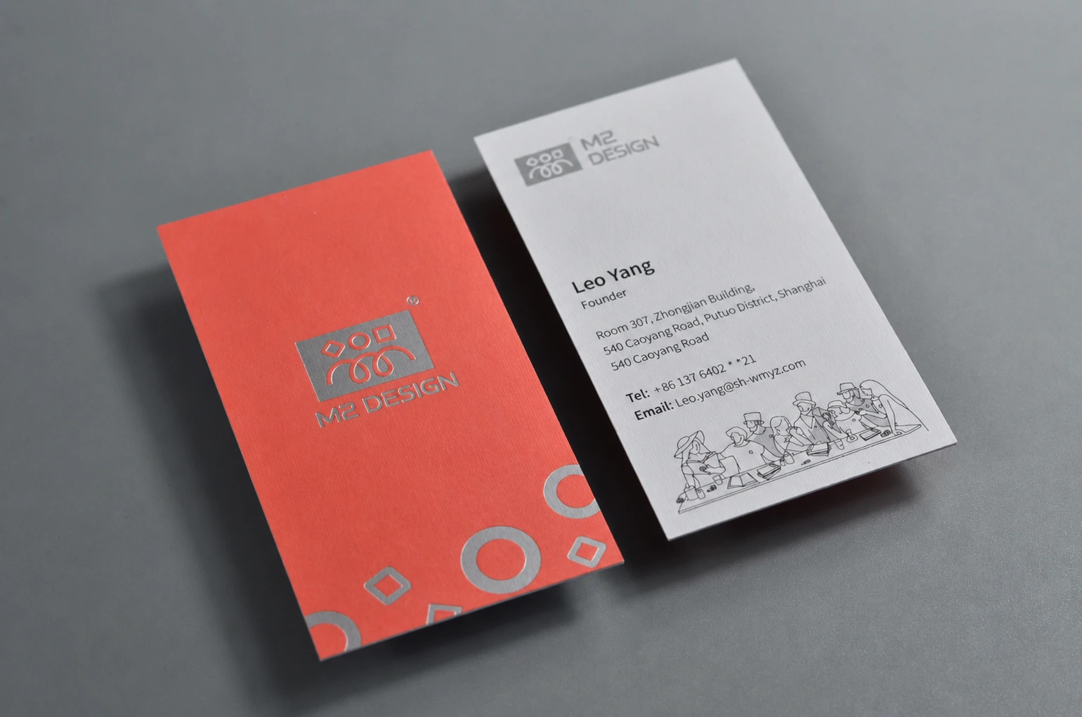 Textured paper business card with coral full coverage spot color printing and white information side