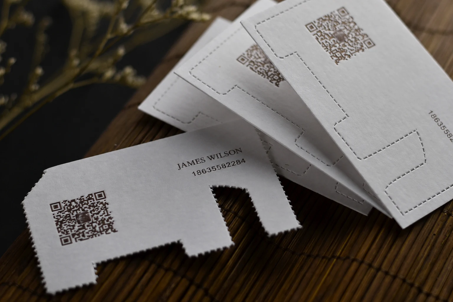 Custom die cut business cards with notched edge detail and clean cut line structure