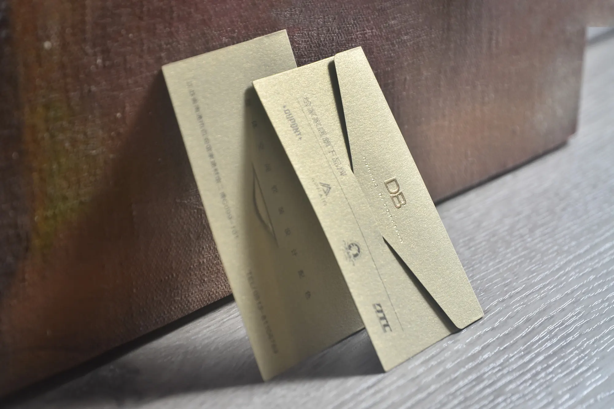 Folded die cut business card sample with custom scored structure and premium paper finish