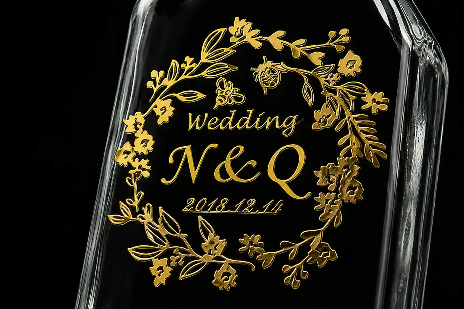 Gold metal transfer decal applied to a dark glass bottle