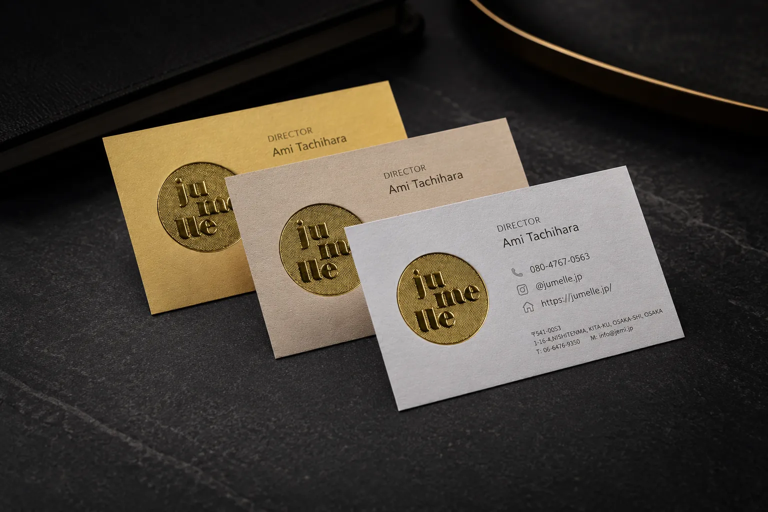 Gold and white business card set with matte gold foil-style logo details and clean professional layout.
