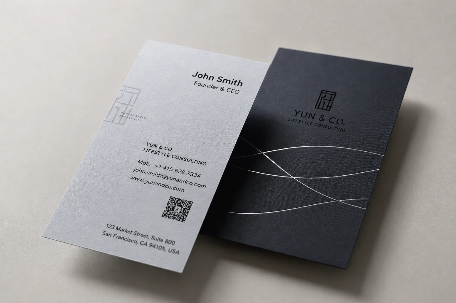 Grey and black thick duplex business cards showing a light front sheet and dark back sheet