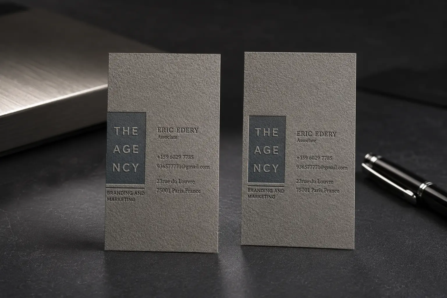 Grey textured paper business card set with subtle tone-on-tone print and premium matte paper surface