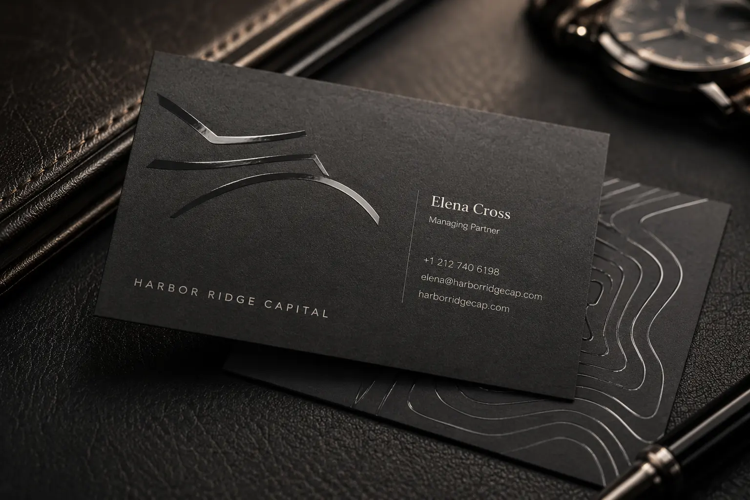 Matte black business card with clear spot UV line pattern and premium dark finish