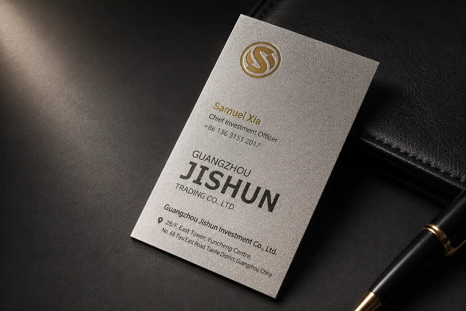 Minimal white business card with gold foil logo and clean corporate typography.