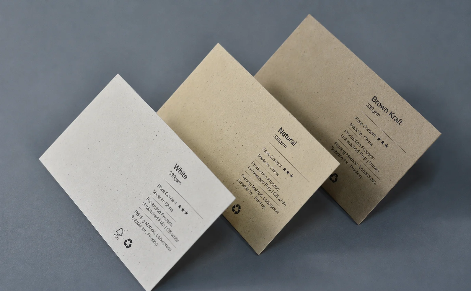 Natural white, ivory and warm earth FSC-certified recycled paper business cards with visible paper texture