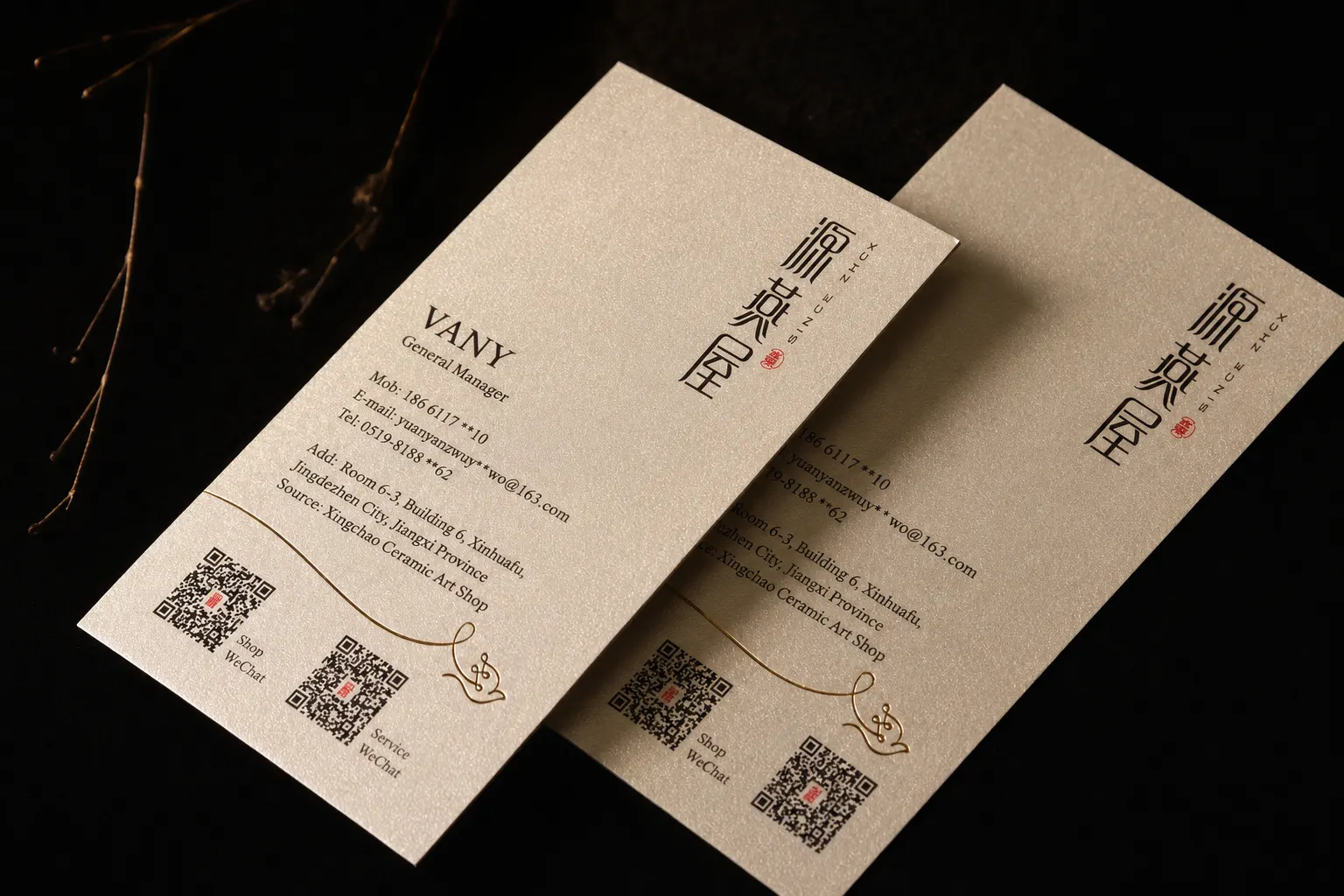 Cream pearlescent business cards with minimal print and QR code