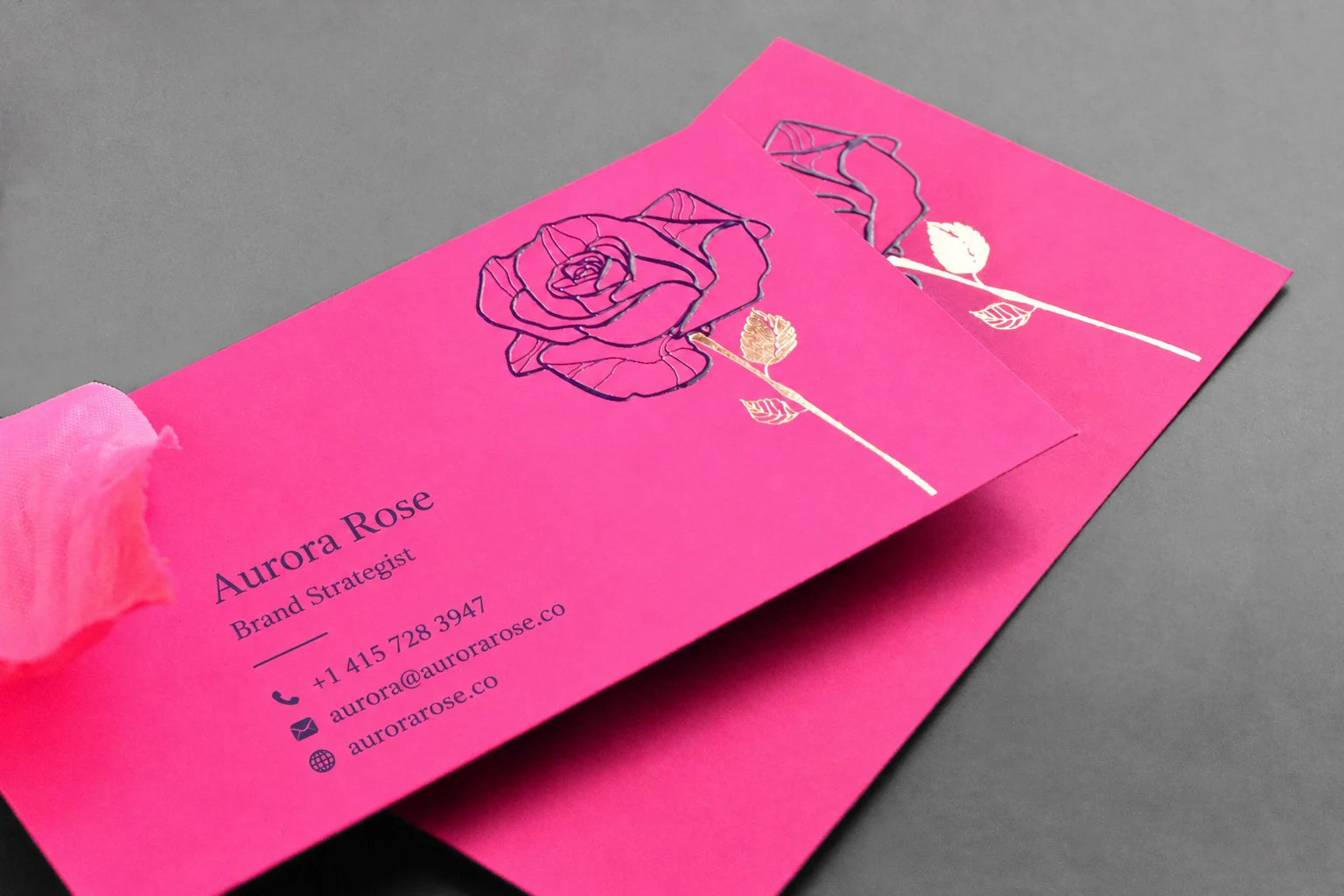 Pink business card with floral line art and subtle gloss finish detail