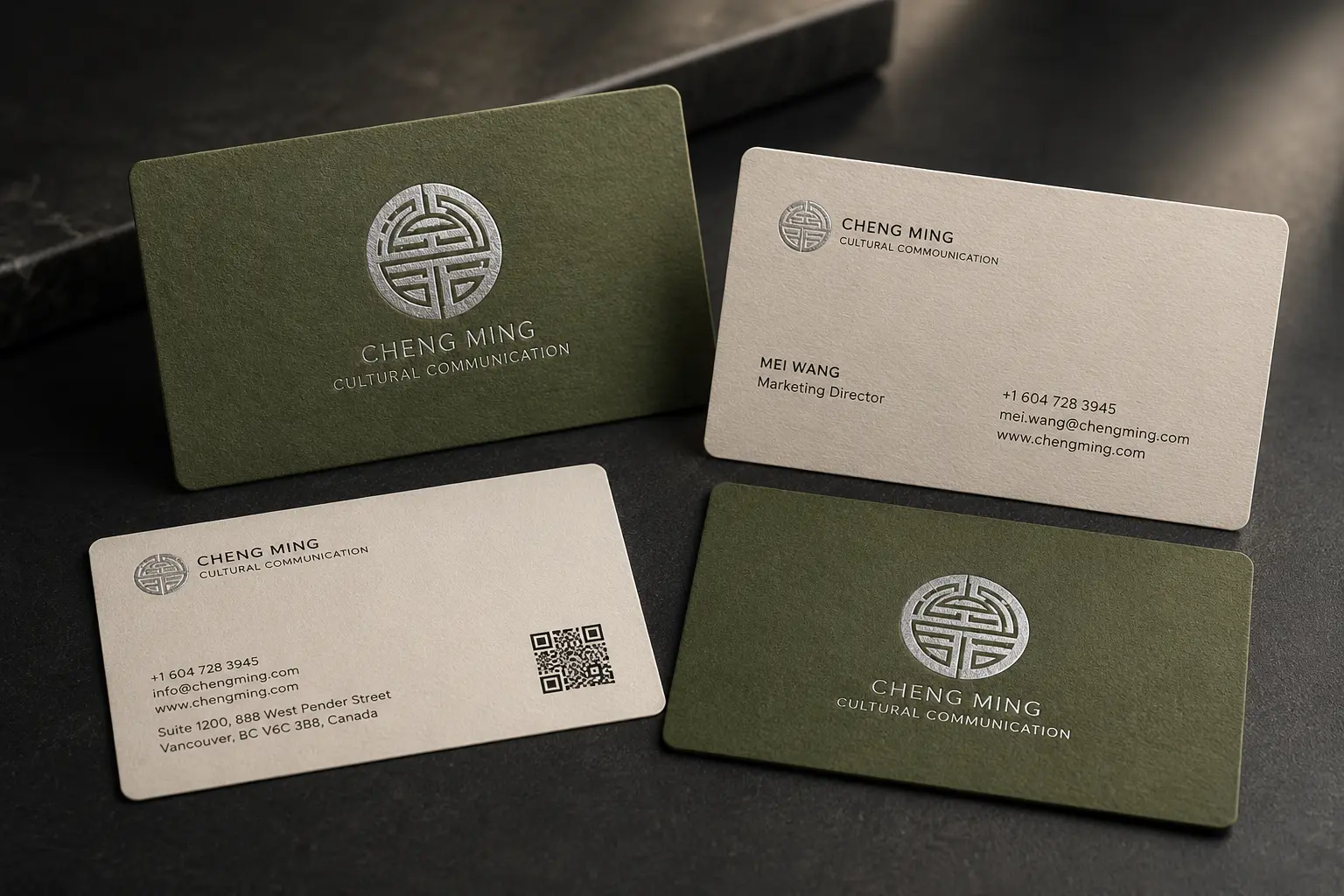 Green and white business cards with silver foil logos and clean service-brand contact details.