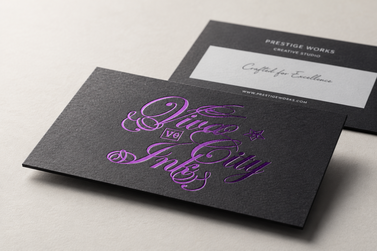 Black and white business cards with purple specialty foil lettering and high-contrast premium detail.