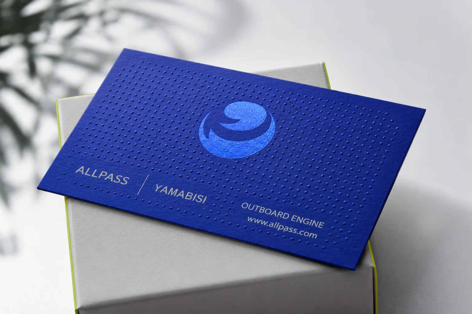 Blue business card with raised spot UV texture and tactile glossy dots
