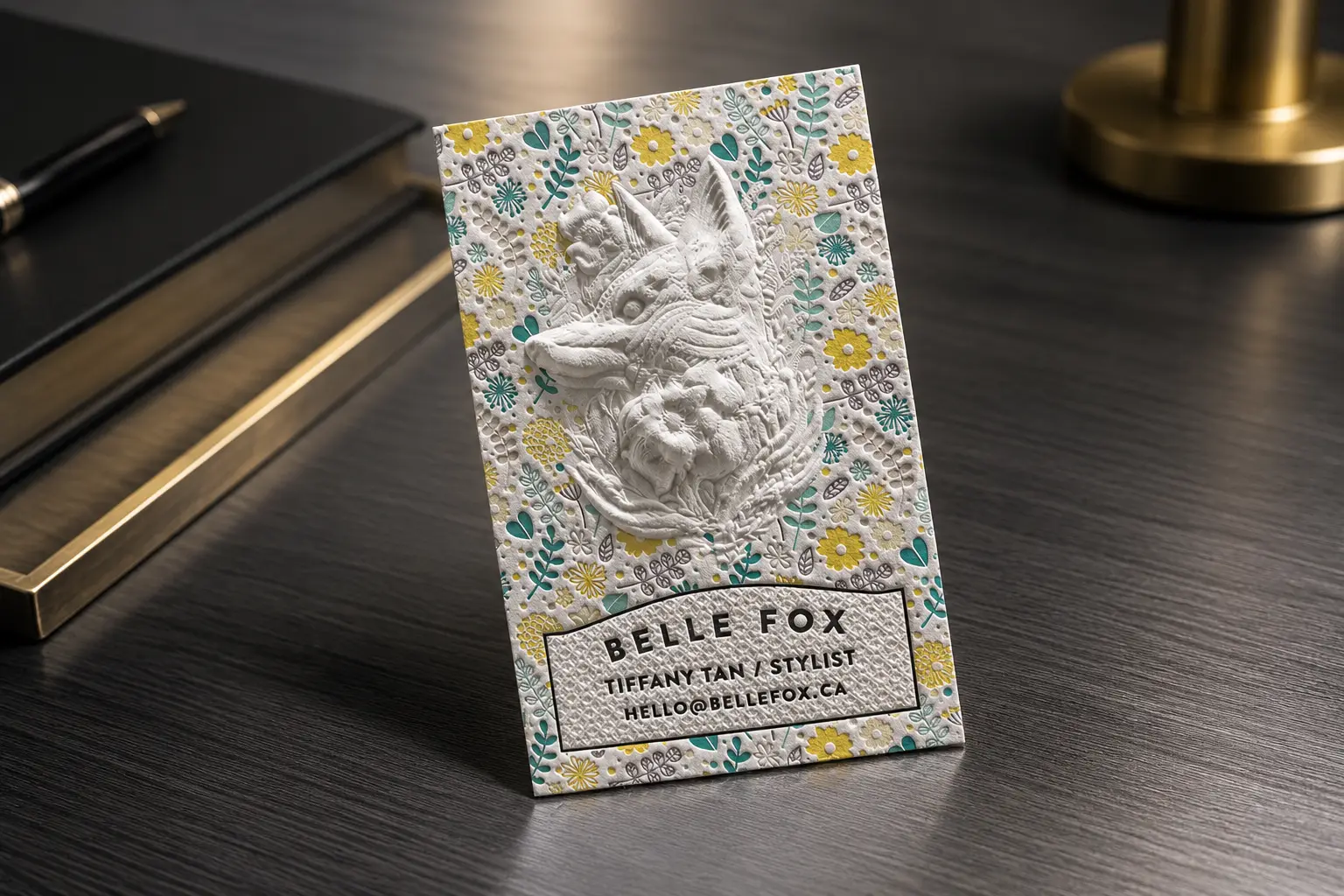 Close-up handheld cotton business card with multi-level sculpted emboss detail