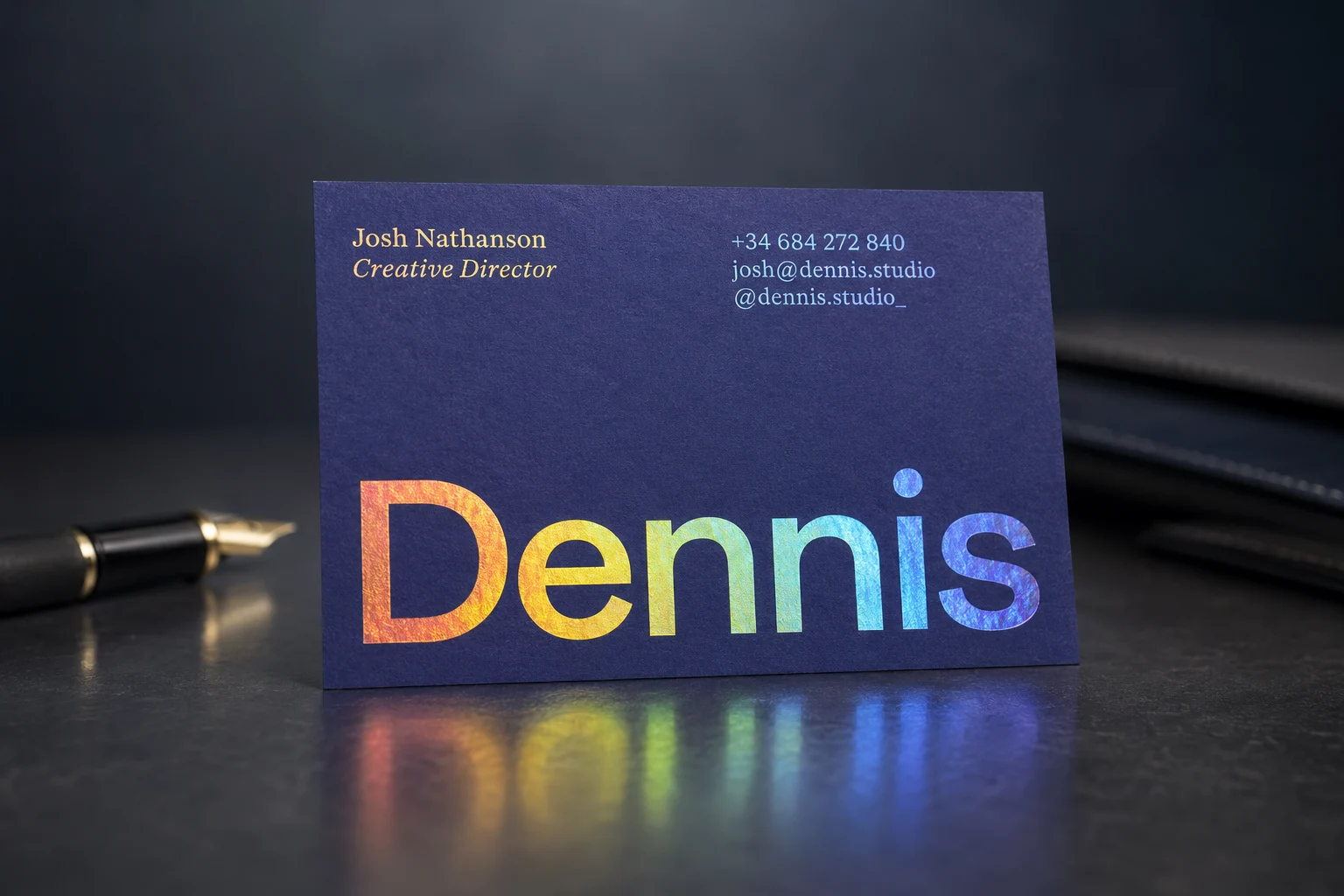 Blue soft touch business card with bold orange metallic foil lettering and clean contact details.
