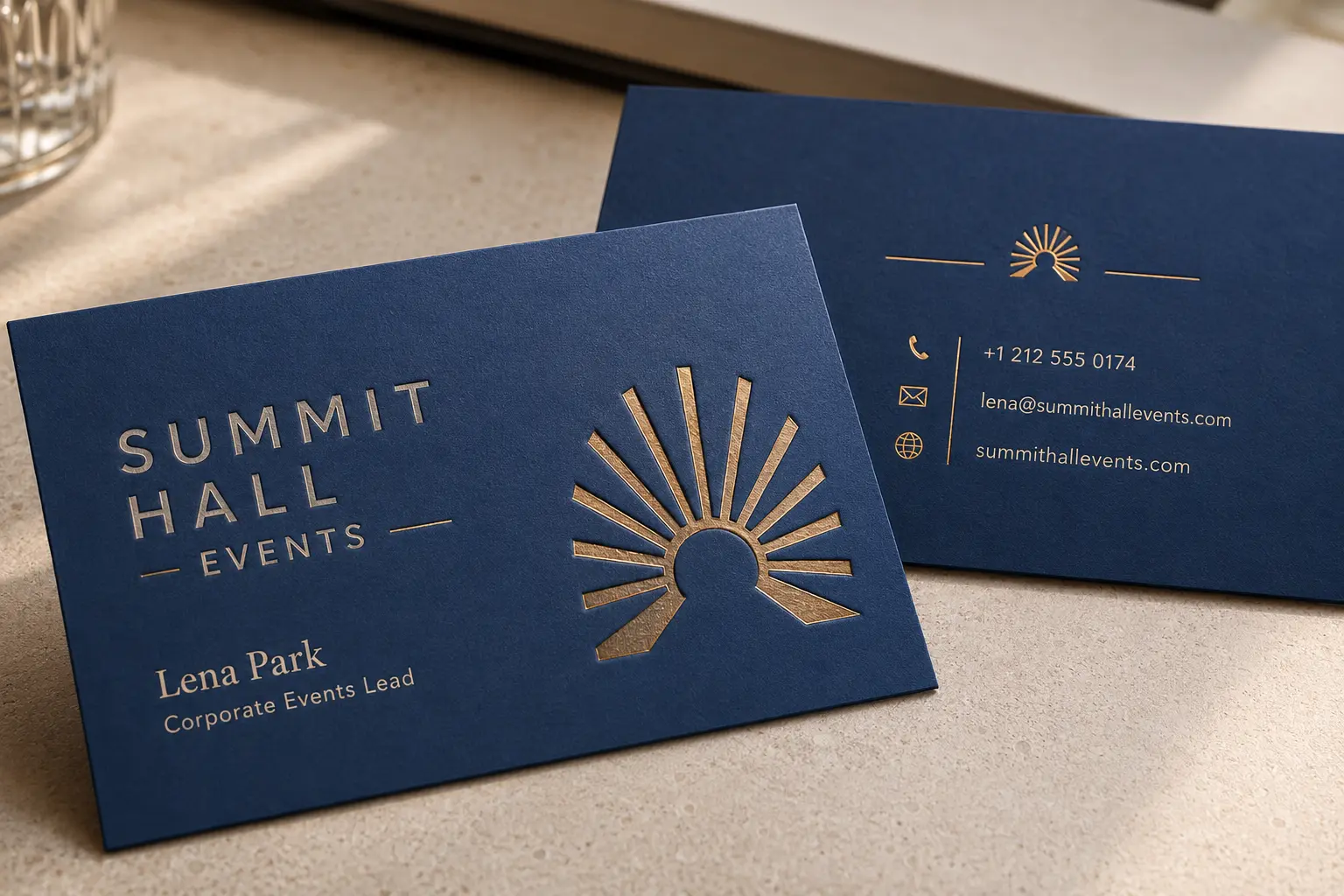 Blue soft touch business cards with a controlled gold foil detail and low-glare matte surface.