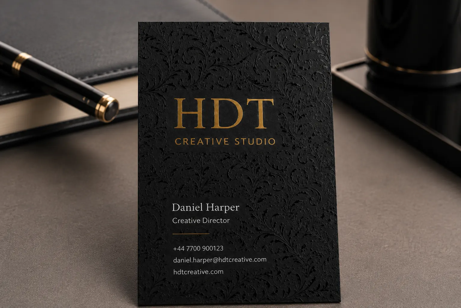 Black business card with separated clear spot UV pattern and debossed gold foil stamping