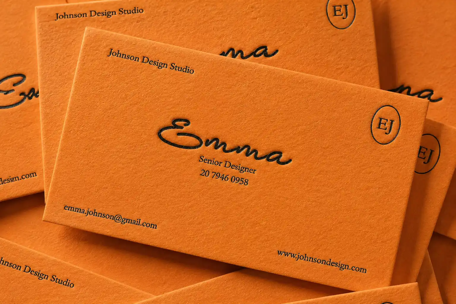 Terracotta orange business card with subtle debossed brand details and warm lifestyle typography.