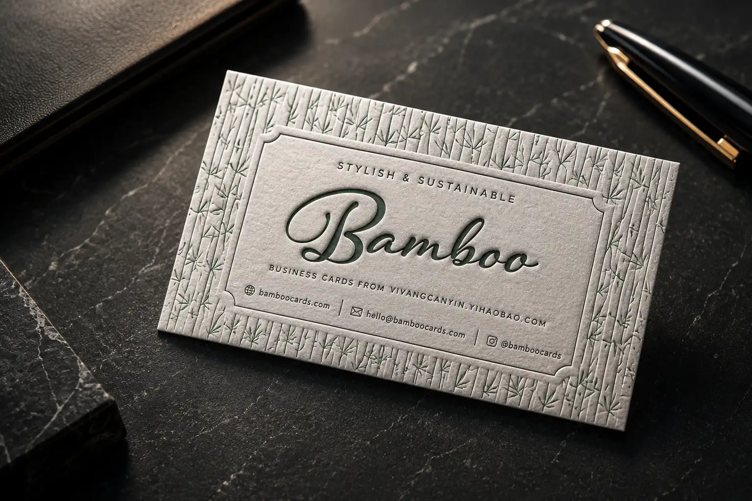 Textured business card with debossed bamboo-style artwork and a natural paper surface.