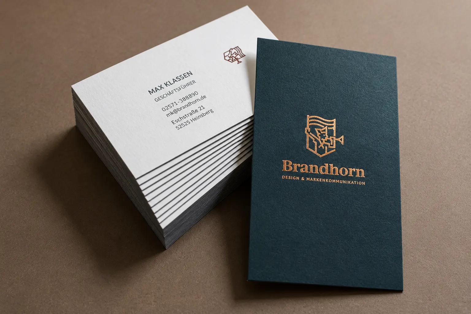 Thick duplex business card stack with white information sheets and deep teal brand color front card