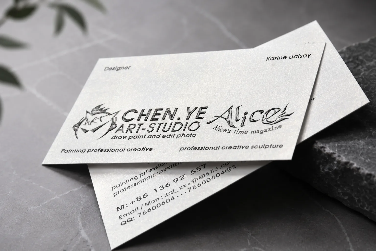 White business card with spot UV signature-style detail and premium printed layout