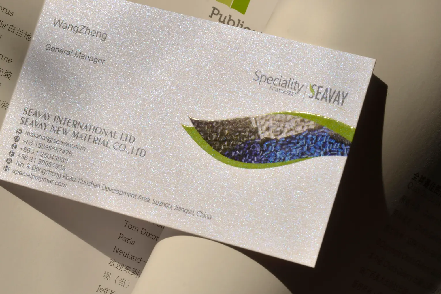 White printed business card sample with gloss varnish detail for finish review