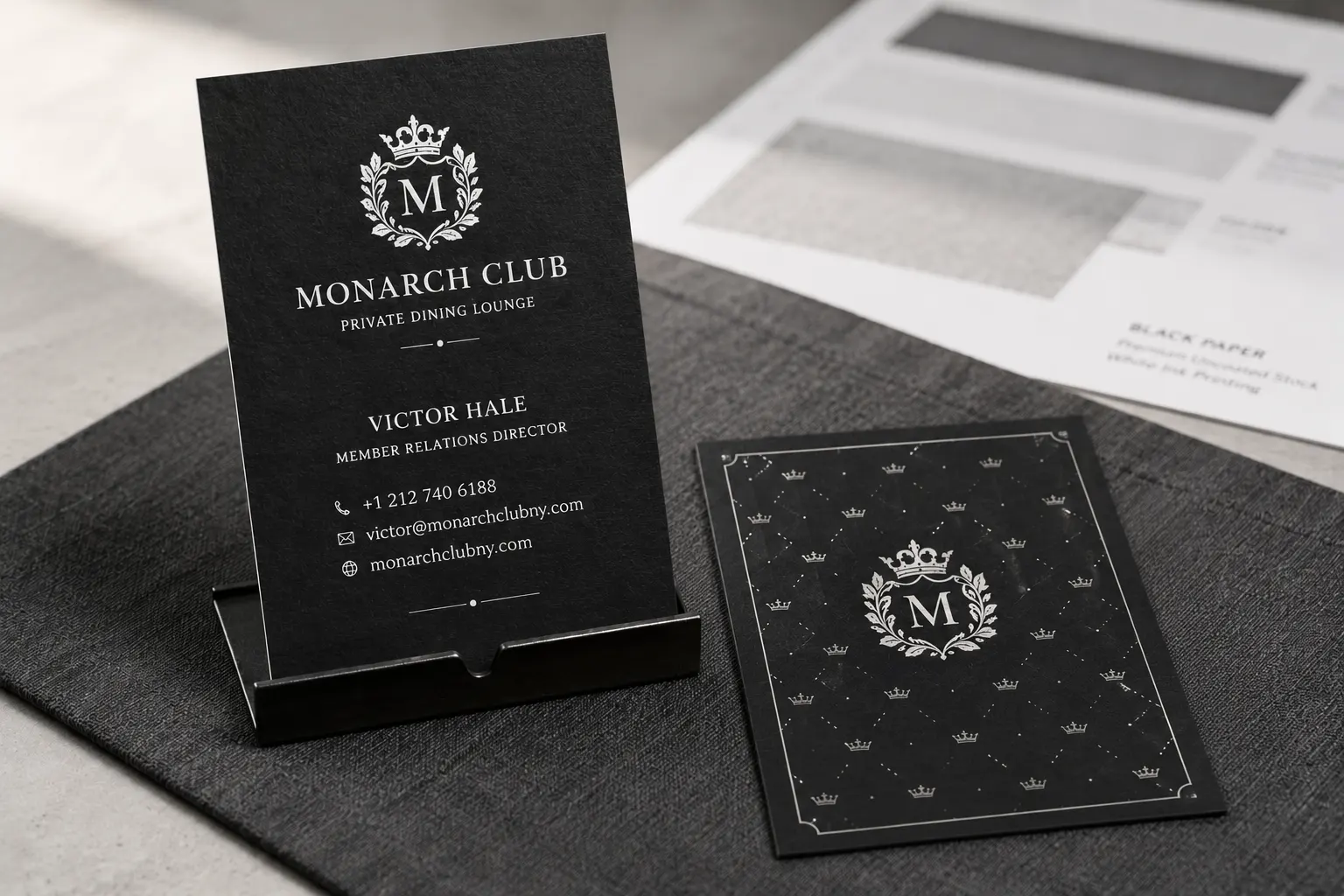 Black paper business cards printed with crisp white ink for a private club style layout.