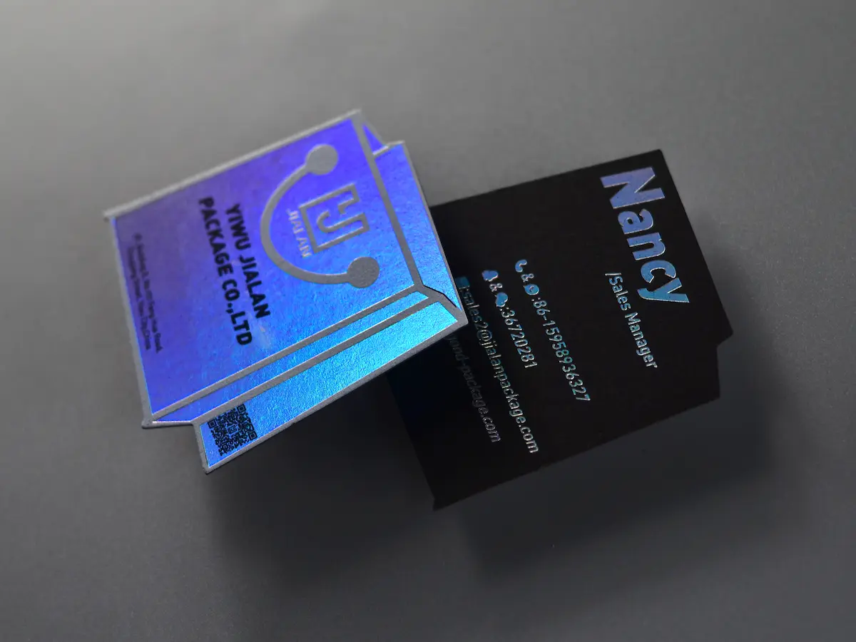 Black cardstock business cards with full-coverage holographic foil stamping.