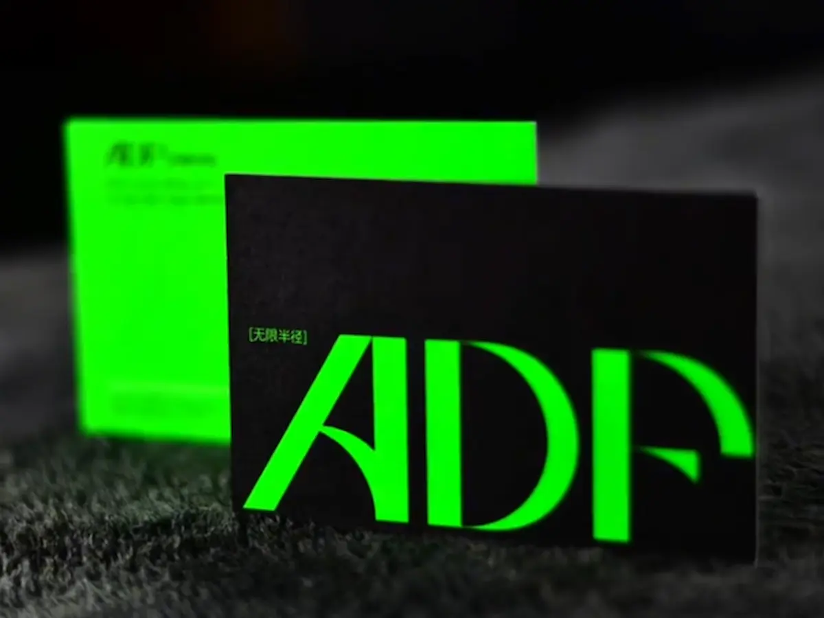 Black cardstock business cards with bright green foil stamping