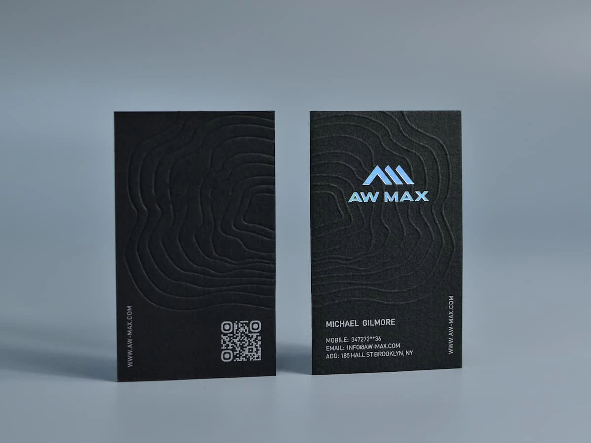 Black cardstock business cards with holographic foil stamping and white ink printing.