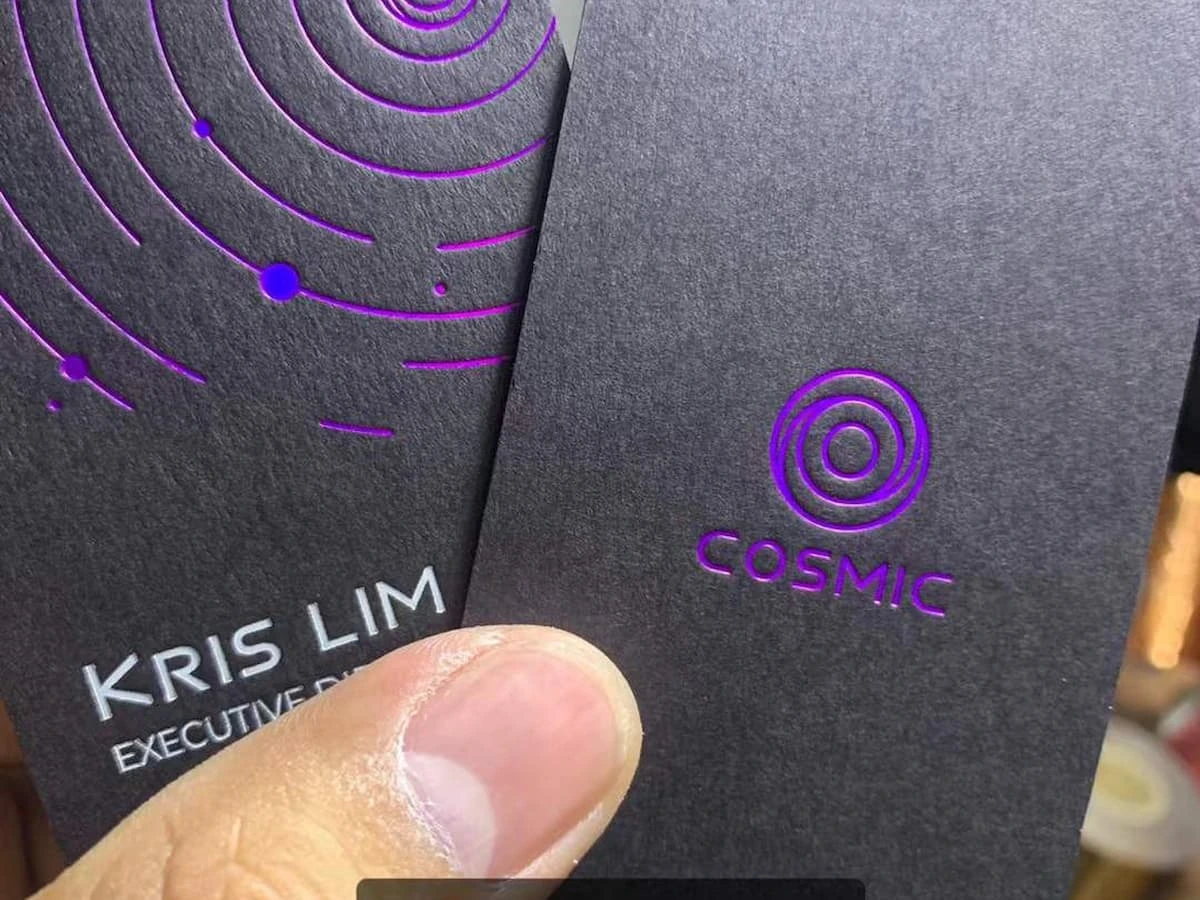 Black cardstock business cards with purple foil and white gold foil stamping.
