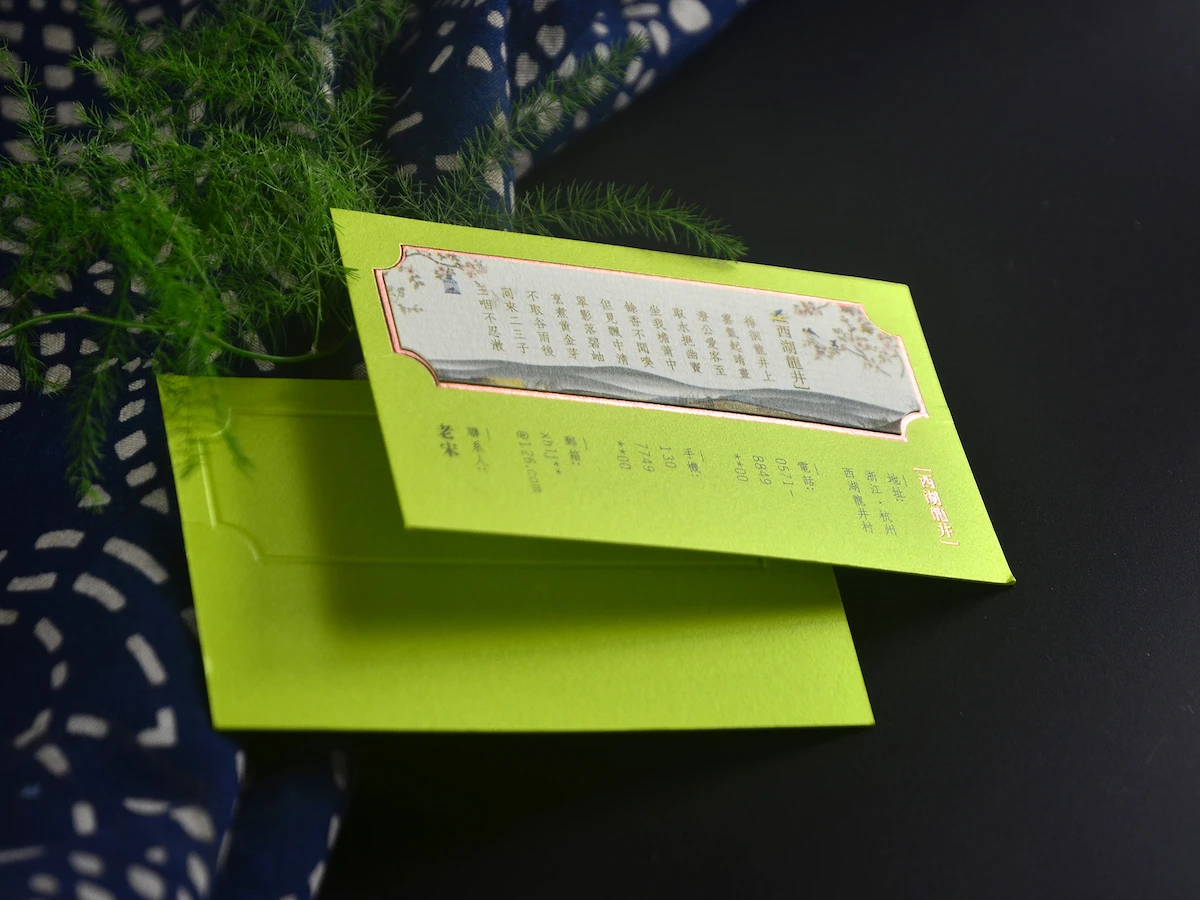 Lime green business cards with a shaped window framing a printed insert